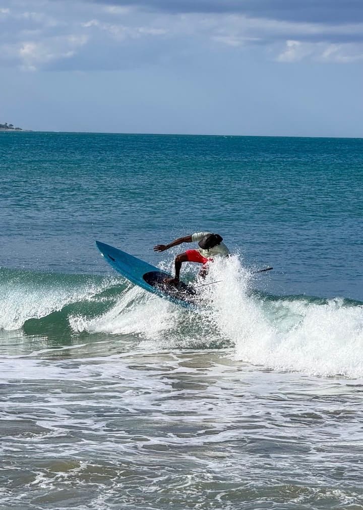A surfer riding a wave at Arugam Bay