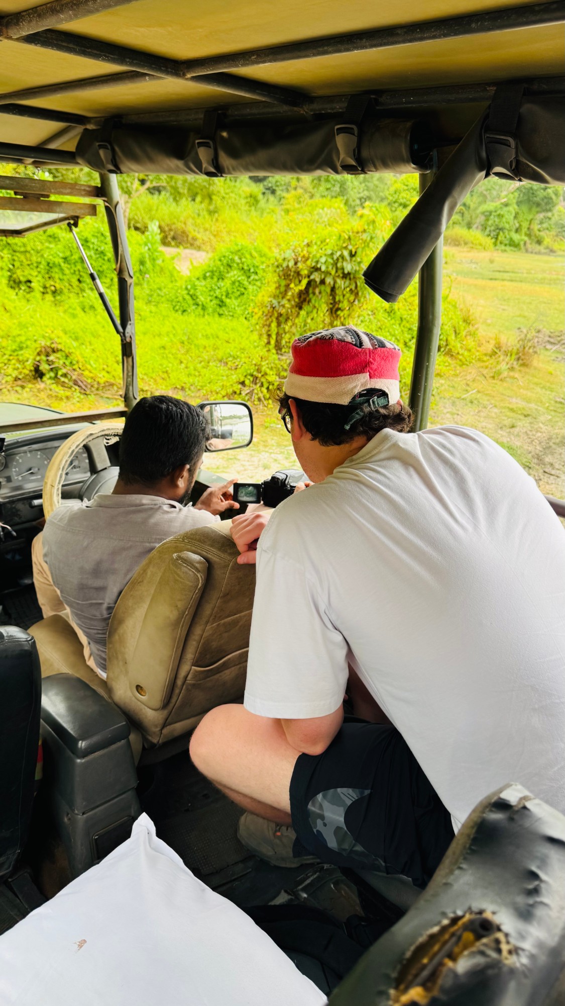 Guests and a driver-tracker watching for wildlife from a safari jeep at Wilpattu